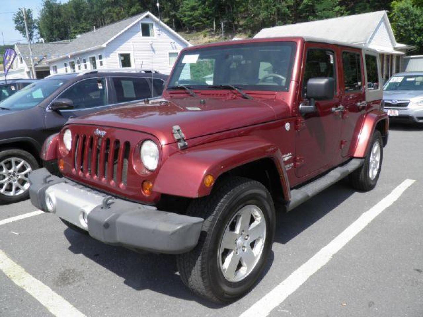 2010 Red Jeep Wrangler Unlimited Sahara 4WD (1J4BA5H13AL) with an 3.8L V6 engine, MAN transmission, located at 19521 New George's Creek Rd SW, Barton, MD, 21521, (301) 463-2404, 39.524323, -79.017906 - Photo#0